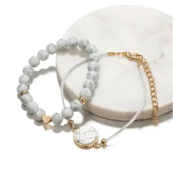 Marble-like beaded geometric bracelet in bohemian four-piece handmade jewelry set with gold accents and crescent moon charm