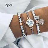 Bohemian four-piece handmade jewelry set with geometric bracelet, layered marble, chain, and charms