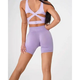 Nvgtn Seamless Pro lavender workout set with strappy sports bra and high-waisted biker shorts