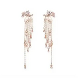 Elegant shining star tassel earrings with crystal strands and rose gold floral accents