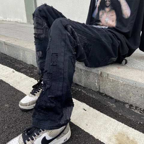 Pair of heavily distressed black jeans from 7TT Original National Chaogao for men