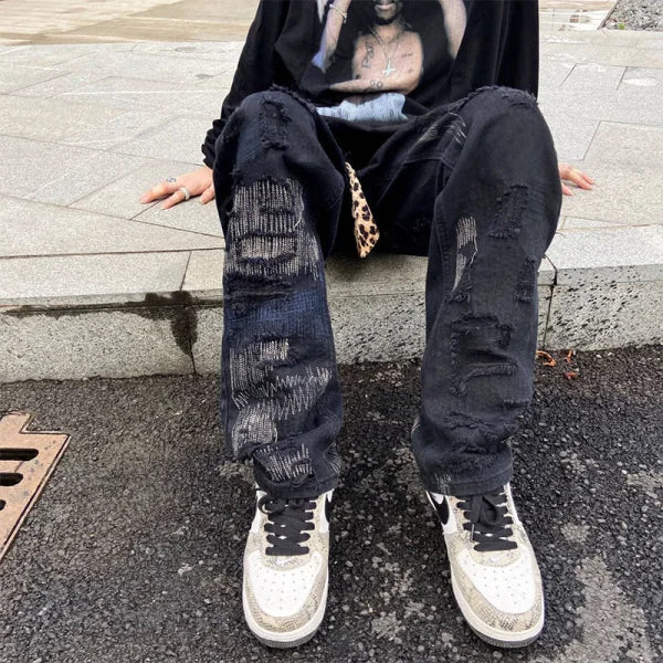 Heavily distressed black jeans styled with white sneakers from 7TT Original National Chaogao
