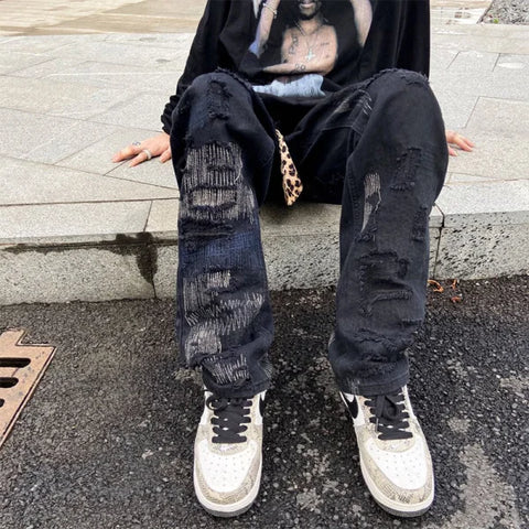 Heavily distressed black jeans styled with white sneakers from 7TT Original National Chaogao