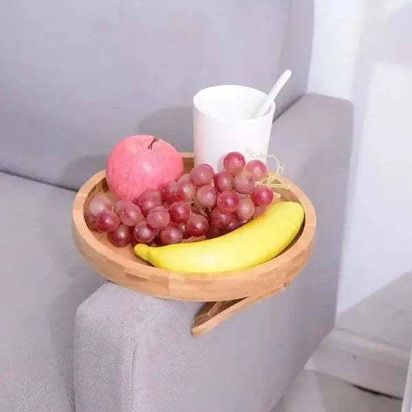 Stylish clip-on sofa armrest with bamboo tray holding fruit and drink