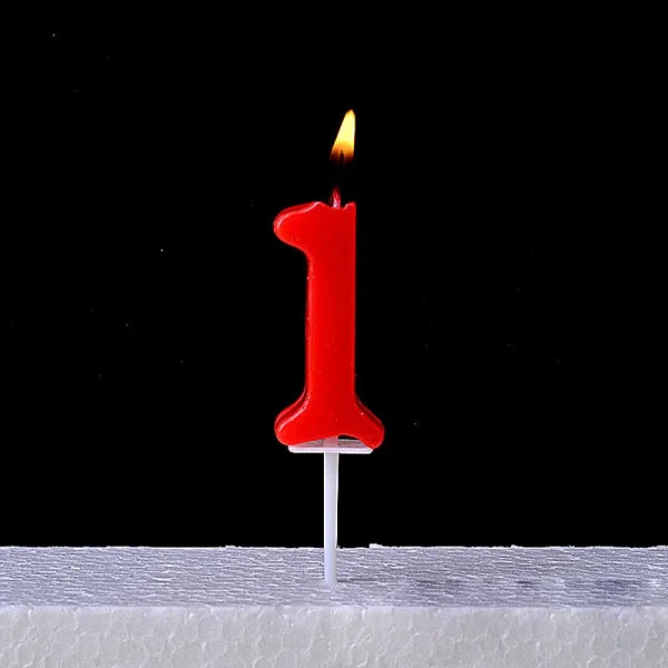 Lit red number one birthday candle atop Champagne Gold Paraffin Candle