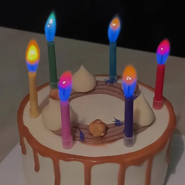 White cake with caramel frosting and Colored Flame Stick Candles for birthday celebrations