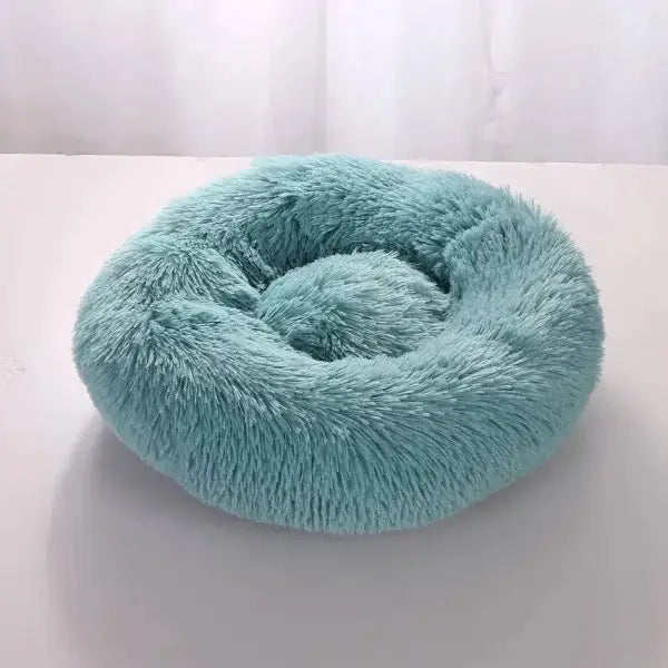 Plush mint-colored round pet bed in comfortable coral fleece for furry friend