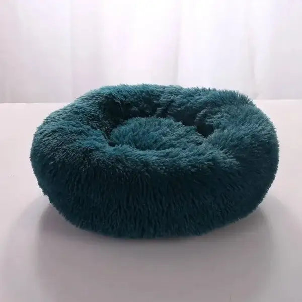 Plush teal round pet bed in comfortable coral fleece for furry friend