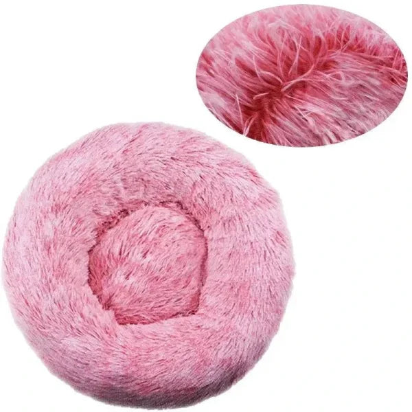 Pink fluffy round pet bed made of comfortable coral fleece for your furry friend