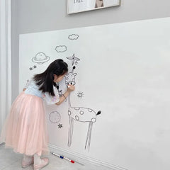 Child drawing giraffe on wall with Electrostatic Whiteboard Sticker