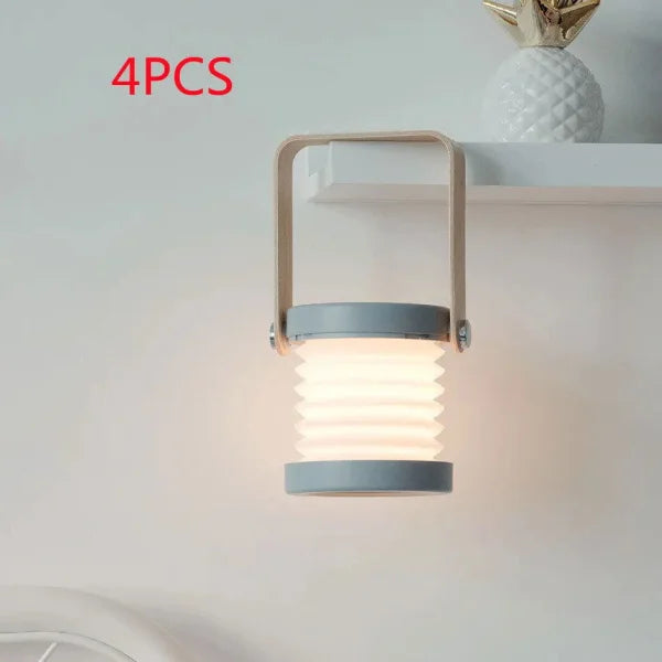 Foldable night light with collapsible white accordion body and blue-gray trim featuring touch control LED
