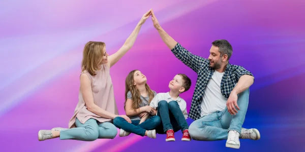 Family of four sitting on a colorful gradient background