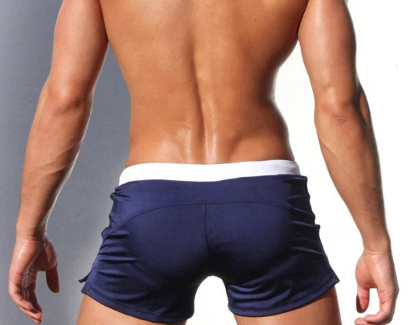 Navy blue boxer briefs with white waistband on muscular male torso from Marcin Men Swimwear