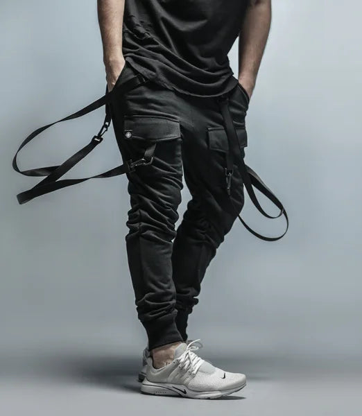 Mens fitness sweatpants: black cargo style with straps, pockets, white sneakers