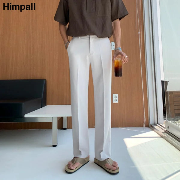 White wide-leg trousers paired with a dark top, ideal casual pants suit for women’s fashion