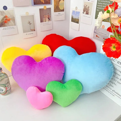 Colorful heart-shaped plush pillows as modern seat cushions for Valentine’s Day