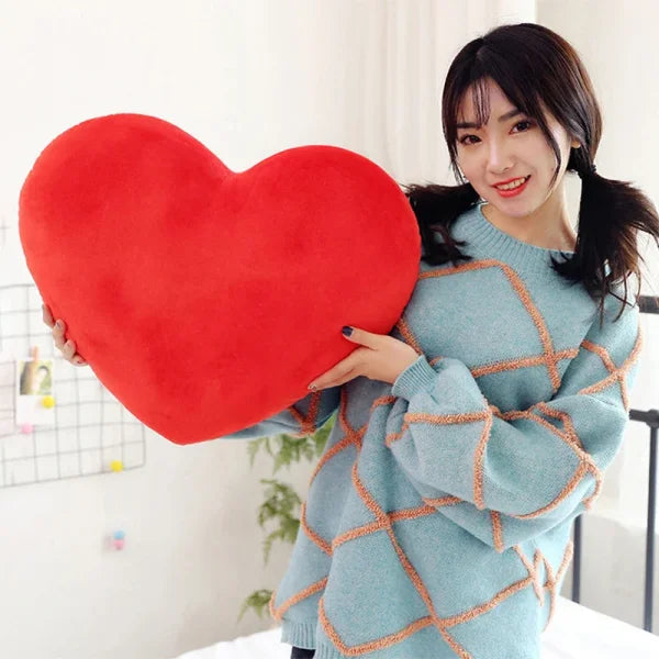 Red heart-shaped seat cushion ideal for Valentine’s Day decorating or as a sleeping pillow