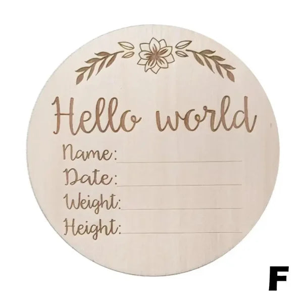 Wooden circular birth announcement plaque with Hello World text using natural wood chips