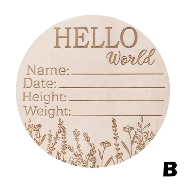 Wooden circular birth announcement sign with Hello World and floral designs, featuring natural wood chips