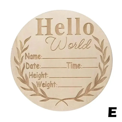 Wooden circular birth announcement sign featuring Hello World and blank spaces for details