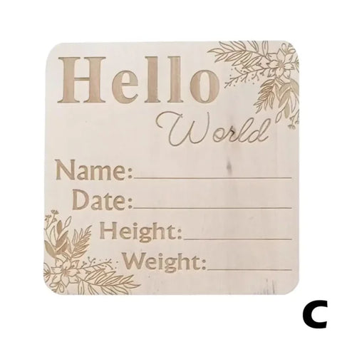 Birth announcement milestone board with Hello World text on natural wood chips design