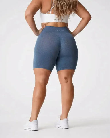 Blue Nvgtn Seamless Pro Spandex Shorts for Men and Women paired with white sneakers