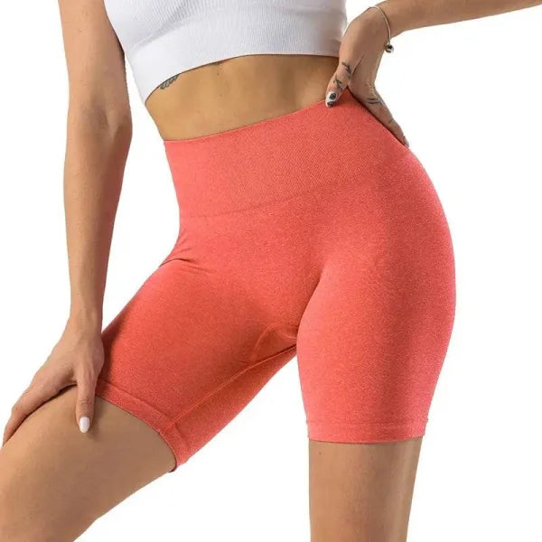 Coral-colored high-waisted Nvgtn Seamless Pro spandex shorts for men and women