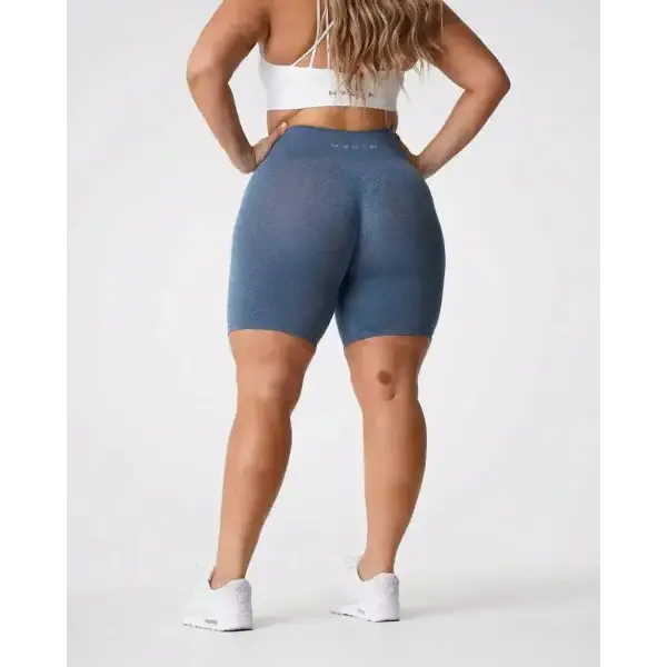 Nvgtn Seamless Pro Spandex Shorts in blue with white sneakers and sports bra