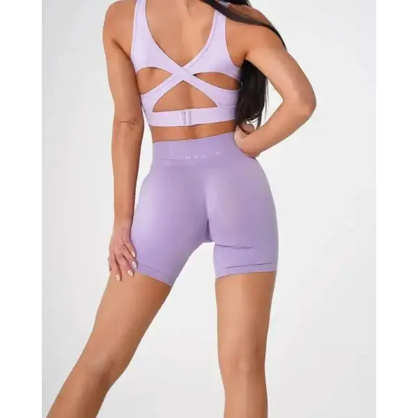Nvgtn Seamless Pro lavender workout set with strappy sports bra and high-waisted biker shorts