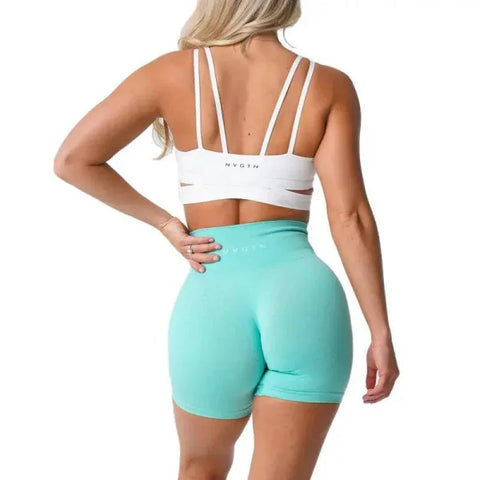 Mint green high-waisted pro spandex shorts with white sports bra from Nvgtn Seamless Pro
