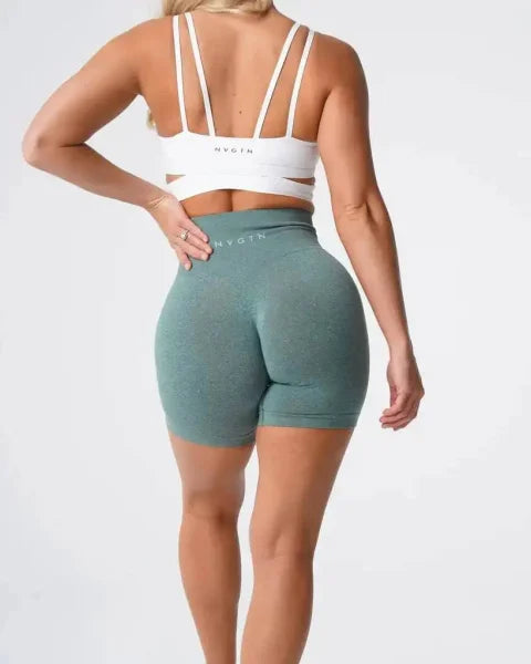 Sage green Nvgtn Seamless Pro Spandex shorts featuring a high-waisted design