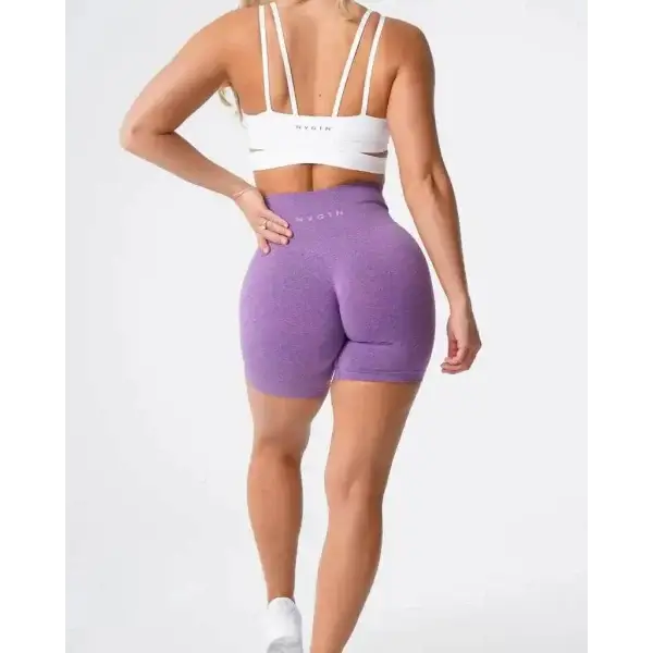 Purple Nvgtn Seamless Pro spandex shorts with white sports bra