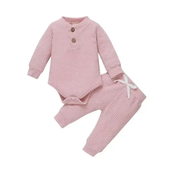 Nvgtn Seamless Pro pink ribbed baby outfit with long-sleeve bodysuit and pants