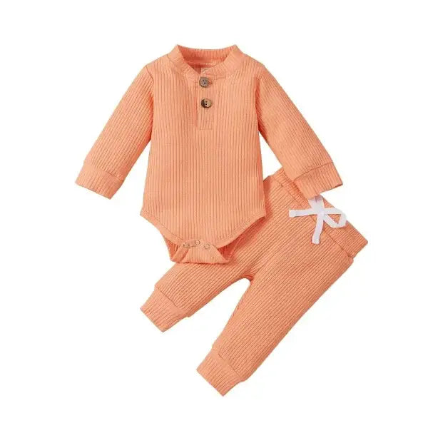 Nvgtn Seamless Pro peach ribbed baby bodysuit and pants with bow