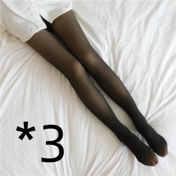 Black sheer fleece lined tights on legs against white fabric for stylish comfort in winter