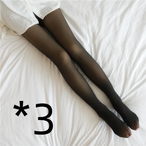 Black sheer fleece lined tights on legs against white fabric for stylish comfort in winter