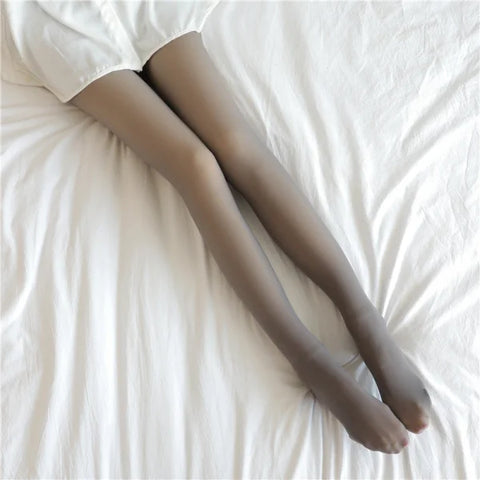 Gray thigh-high stockings on white fabric, ideal fleece lined tights for comfort in winter