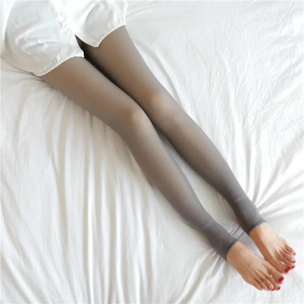 Legs with coffee skin in grey fleece lined tights on white fabric for comfort