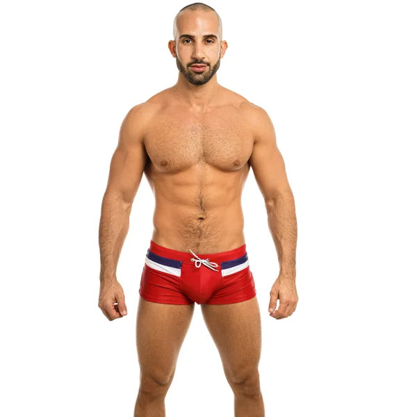 Muscular shirtless man in red swim briefs showcases Premium Comfort Fit Boxer Shorts Men