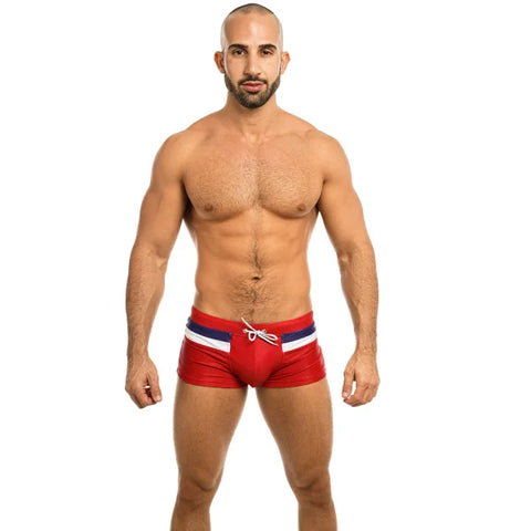 Muscular shirtless man in red swim briefs showcases Premium Comfort Fit Boxer Shorts Men