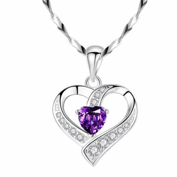 Heart-shaped silver pendant with purple gemstone and crystal accents in sterling silver necklace