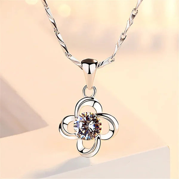 Sterling Silver Necklace featuring a four-petal flower pendant and central crystal stone