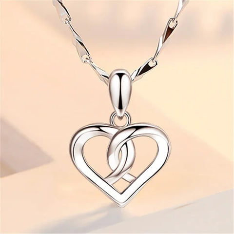 Sterling silver necklace featuring a heart-shaped pendant with interlocking design