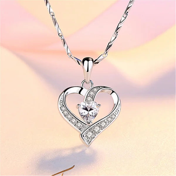 Sterling silver necklace featuring a heart-shaped pendant with diamonds and zircon stone