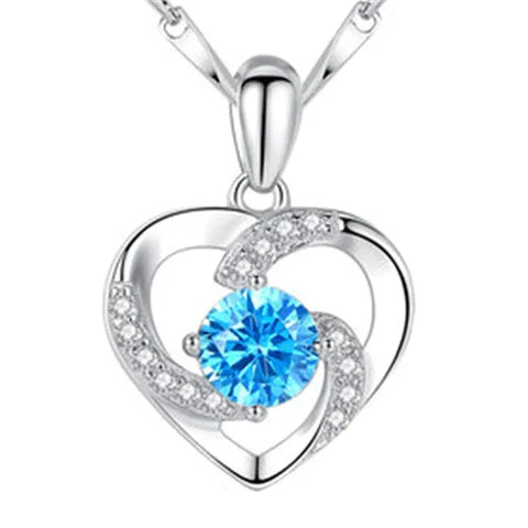 Sterling silver necklace pendant featuring blue crystal and diamond accents