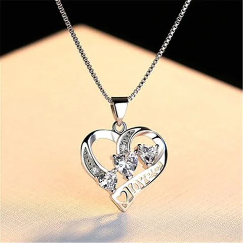 Sterling silver necklace featuring a heart-shaped pendant with crystal accents