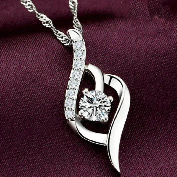 Sterling silver necklace featuring a heart-shaped pendant with diamonds and zircon stone