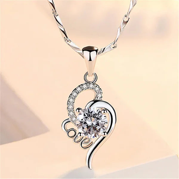 Sterling silver necklace featuring a heart-shaped pendant with crystal embellishments