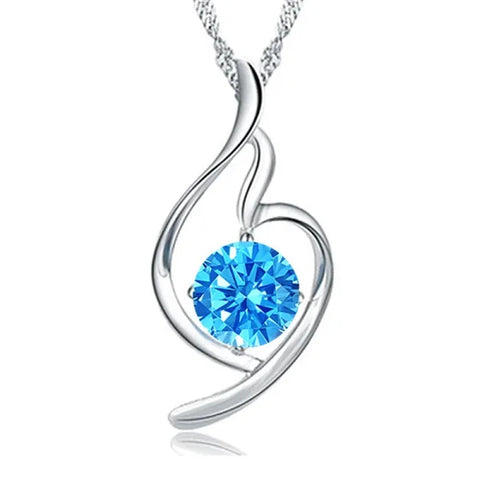 Sterling silver necklace featuring a heart-shaped pendant with blue crystal centerpiece