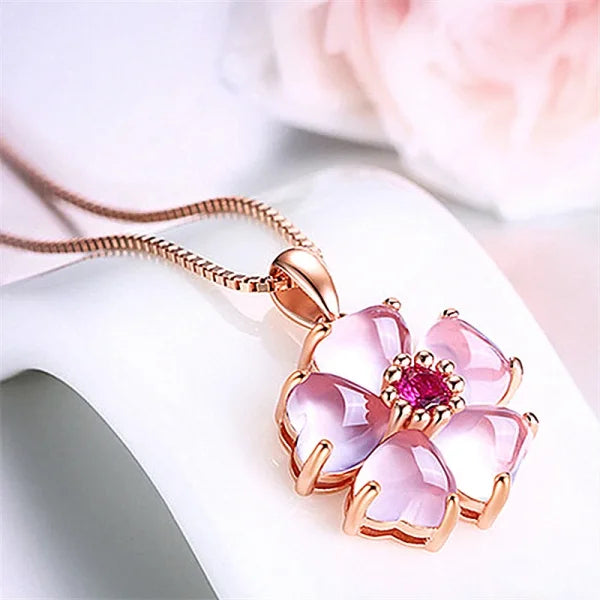 Delicate rose gold sterling silver necklace with pink crystal flower pendant and red stone